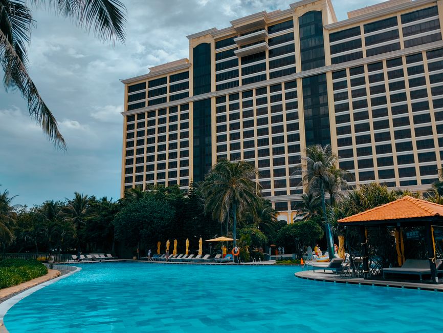 Stunning resort building with a tropical poolside setting and palm trees in a vibrant outdoor environment.