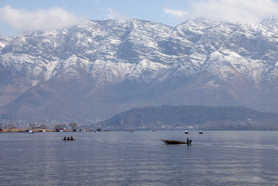 Breathtaking view of Dal Lake with snowy Himalayas in the background in Srinagar.