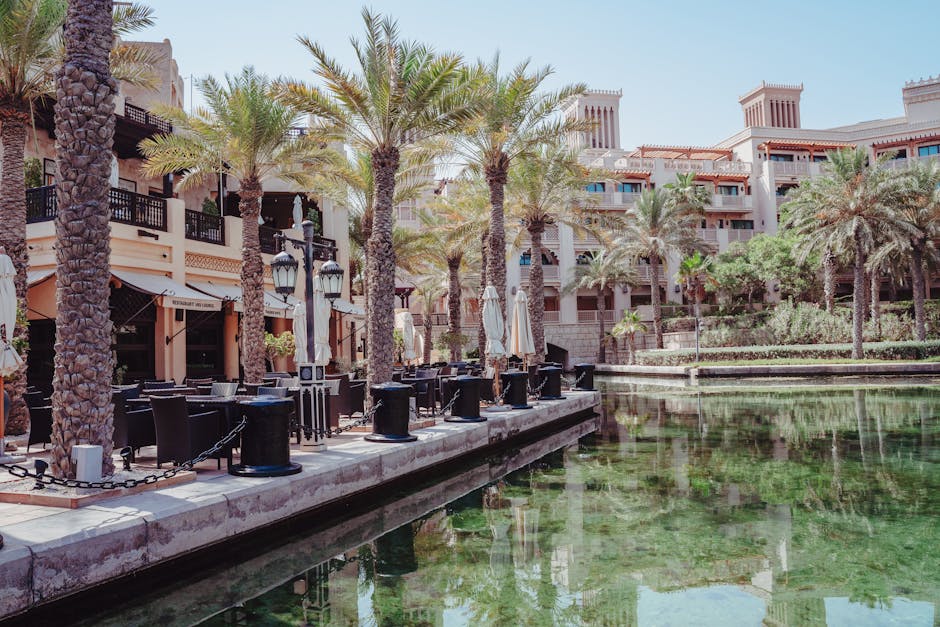 Peaceful scene of Madinat Jumeirah's lavish architecture and serene water reflection.