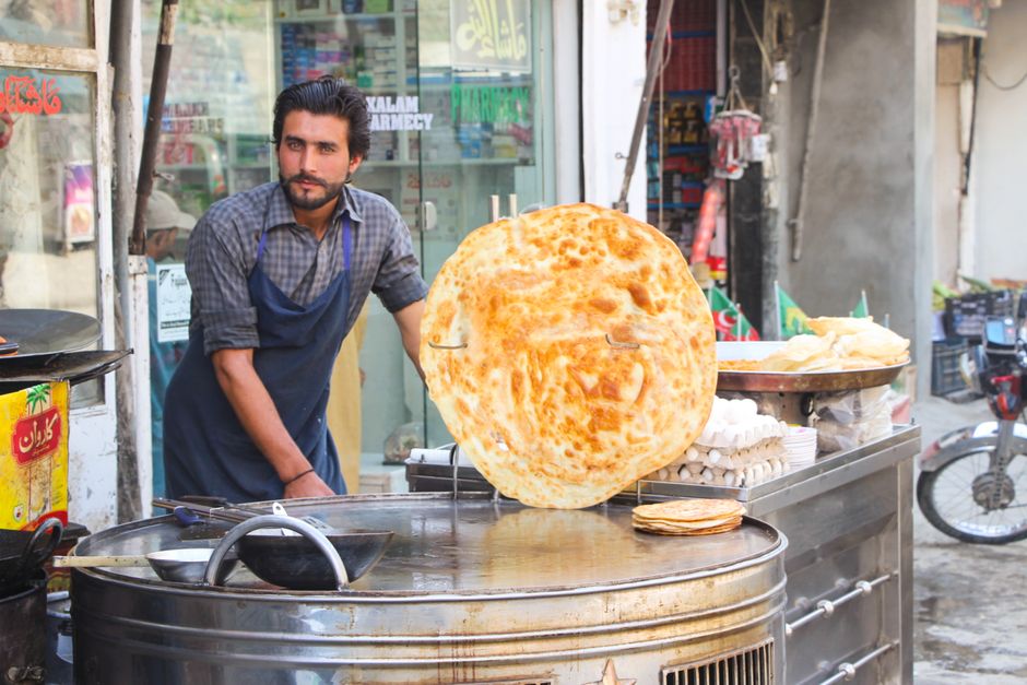 Local chef prepares giant paratha at a street food stall in Kalam Bazaar, Pakistan.