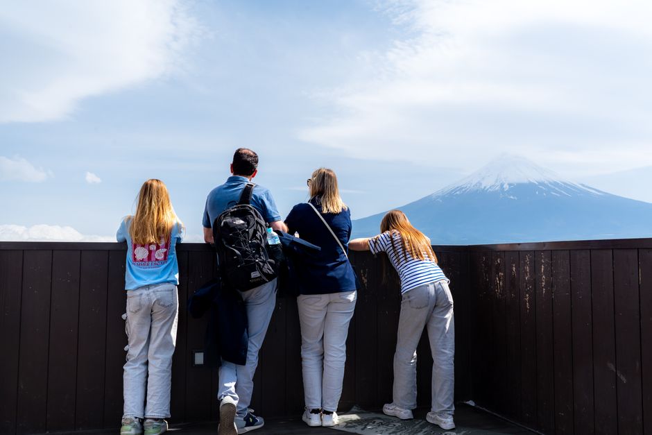 Group of tourists viewing Mount Fuji from Fujinomiya, Japan. Clear day with scenic mountain view.