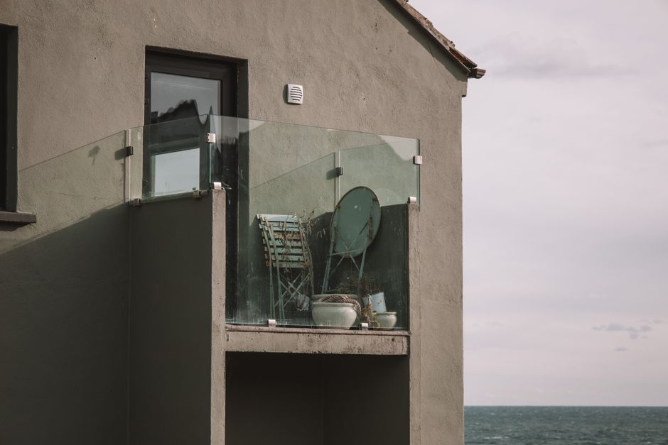 A minimalist glass balcony with coastal views in Dublin, Ireland. Perfect for contemporary homes.