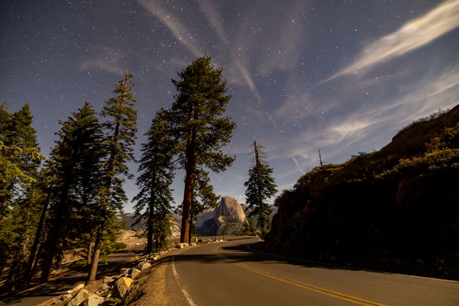 Scenic view of Half Dome beneath a starry night sky at Yosemite National Park.