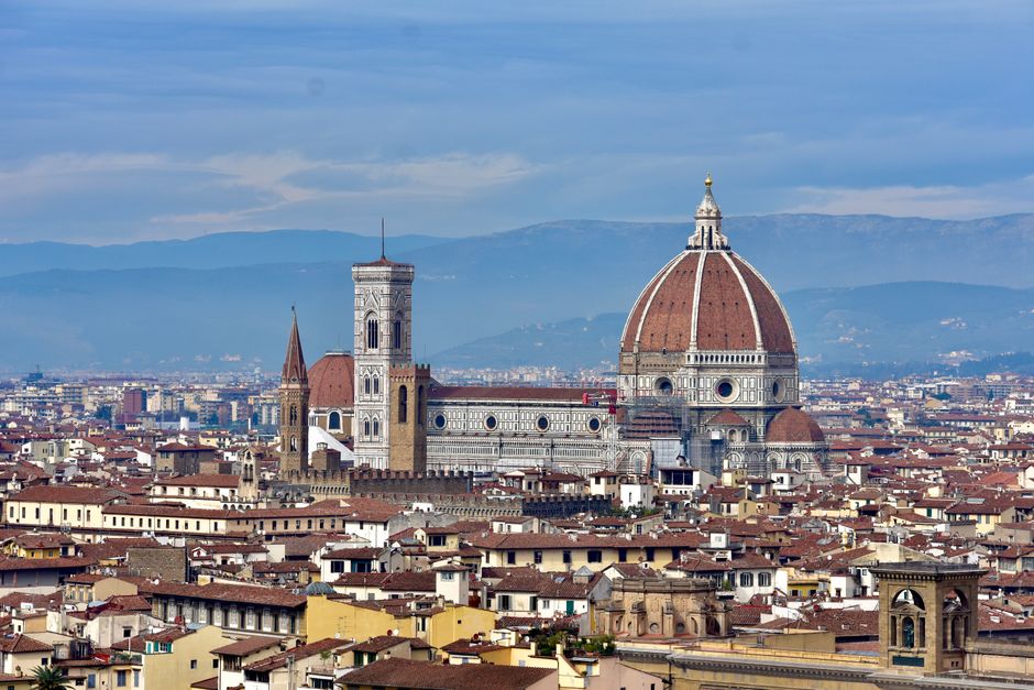 A breathtaking aerial view of Florence's iconic Duomo and cityscape set against a Tuscan backdrop.