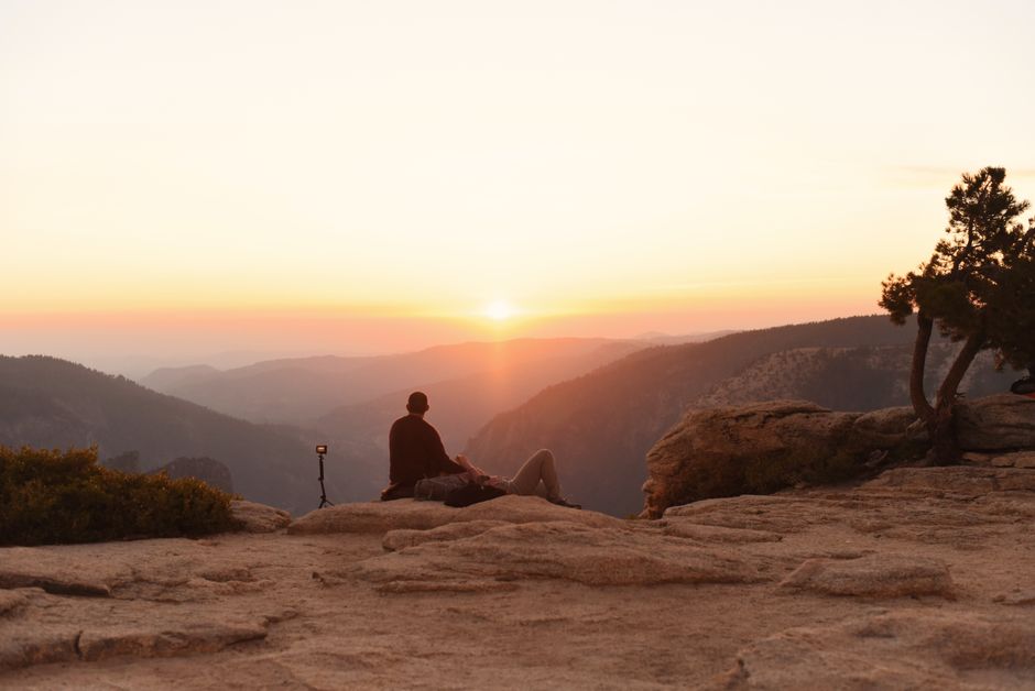 A person enjoying a tranquil sunrise view at Yosemite National Park, California.